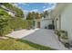Private patio with mature hedge, table and chairs and gas grill create an outdoor entertaining space at 1219 Oakley St, Orlando, FL 32806
