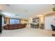 Finished basement features projector screen, leather reclining sofa, and dining table at 127 Heatherbrooke Cir, Oviedo, FL 32765