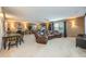 Spacious basement entertainment area with a dining table and leather reclining sofa set at 127 Heatherbrooke Cir, Oviedo, FL 32765