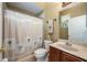 Bathroom showcases a vanity, toilet, and shower with decorative palm tree curtain at 127 Heatherbrooke Cir, Oviedo, FL 32765