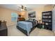 This bedroom features a ceiling fan, neutral carpet, and a window for natural light at 127 Heatherbrooke Cir, Oviedo, FL 32765