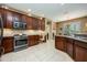 Lovely kitchen with stainless steel appliances, stone backsplash, and tile floors for easy maintenance and cleaning at 127 Heatherbrooke Cir, Oviedo, FL 32765