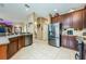 Well-appointed kitchen with stainless steel appliances, wood cabinetry, and open layout perfect for entertaining guests at 127 Heatherbrooke Cir, Oviedo, FL 32765