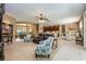 Open-concept living room features plush seating, neutral tones, and seamless flow to the dining and kitchen areas at 127 Heatherbrooke Cir, Oviedo, FL 32765