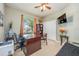 Comfortable home office features a large desk, ceiling fan, and view to the outdoors at 127 Heatherbrooke Cir, Oviedo, FL 32765