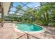 A screened-in pool is surrounded by tropical landscaping for privacy and a resort-like feel at 127 Heatherbrooke Cir, Oviedo, FL 32765
