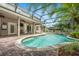 Screened-in pool with tropical landscaping provides a private, tranquil backyard oasis at 127 Heatherbrooke Cir, Oviedo, FL 32765