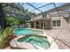 Inviting screened-in pool and spa area offers a relaxing outdoor retreat with a covered patio and lush landscaping at 127 Heatherbrooke Cir, Oviedo, FL 32765