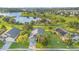 Stunning aerial view of home and lake, showcasing a well-manicured lawn and beautiful surrounding neighborhood at 1315 Vista Del Lago Blvd, Dundee, FL 33838