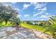An outdoor patio with stone pavers has picturesque views of the neighborhood lake and open fields at 1315 Vista Del Lago Blvd, Dundee, FL 33838