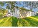 A green backyard with a stone walkway and a view of the trees and blue skies at 1315 Vista Del Lago Blvd, Dundee, FL 33838