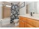 Cozy bathroom featuring a bathtub, shower, floral shower curtain, and updated fixtures at 1315 Vista Del Lago Blvd, Dundee, FL 33838