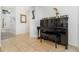 Elegant entryway featuring a black piano, tasteful decor, and a glimpse of the open floor plan beyond at 1315 Vista Del Lago Blvd, Dundee, FL 33838