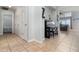 Bright entryway with tile flooring and neutral wall paint, featuring a piano and glimpse into the living space at 1315 Vista Del Lago Blvd, Dundee, FL 33838