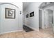 Bright hallway featuring tile flooring, neutral paint, and decorative artwork, offering a welcoming ambiance at 1315 Vista Del Lago Blvd, Dundee, FL 33838