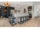 Modern kitchen featuring a large island with seating, stainless steel appliances, and stylish lighting at 1315 Vista Del Lago Blvd, Dundee, FL 33838