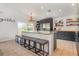 Bright kitchen features an island with bar seating, granite countertops, and stainless steel appliances at 1315 Vista Del Lago Blvd, Dundee, FL 33838
