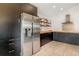 Modern kitchen design with stainless steel refrigerator and sleek, dark cabinetry at 1315 Vista Del Lago Blvd, Dundee, FL 33838
