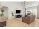 Bright living room with large windows, tile flooring, and a comfortable seating arrangement for relaxation at 1315 Vista Del Lago Blvd, Dundee, FL 33838