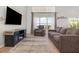 Cozy living room with a large window, comfortable seating, and stylish decor for relaxing evenings at 1315 Vista Del Lago Blvd, Dundee, FL 33838