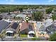Wide aerial view of a residential neighborhood featuring lush tree coverage and diverse single-Gathering homes at 144 Bridgeton St, Davenport, FL 33896
