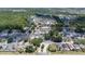 An aerial view of a residential community with mature trees, ponds, and well-kept homes at 144 Bridgeton St, Davenport, FL 33896