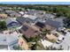 Sunlit aerial shot of a residential neighborhood with diverse home styles, screened patios and lush green landscaping at 144 Bridgeton St, Davenport, FL 33896