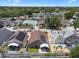 Wide aerial view of a residential neighborhood featuring lush tree coverage and diverse single-Gathering homes at 144 Bridgeton St, Davenport, FL 33896