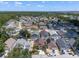 Bright aerial showcasing a residential neighborhood featuring diverse homes, mature trees, and community amenities at 144 Bridgeton St, Davenport, FL 33896