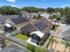 Aerial view of a home with solar panels, fenced yard, and a screened patio at 144 Bridgeton St, Davenport, FL 33896