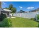 Green backyard with a patio, privacy fence, and mature landscaping at 144 Bridgeton St, Davenport, FL 33896
