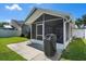 Relax in this cozy screened in patio, complemented by a pristine backyard and lush green lawn at 144 Bridgeton St, Davenport, FL 33896