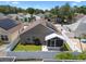 Well-maintained fenced backyard with a screened-in patio, lawn, and landscaped garden beds at 144 Bridgeton St, Davenport, FL 33896