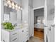 Bright bathroom features white vanity, marble countertop, and doorway to primary bedroom at 144 Bridgeton St, Davenport, FL 33896