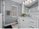 Elegant bathroom with marble vanity, white cabinets, and tiled flooring at 144 Bridgeton St, Davenport, FL 33896