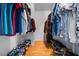 Walk-in closet featuring hardwood floors and ample storage for clothes and shoes at 144 Bridgeton St, Davenport, FL 33896