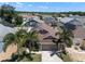 Exterior view showcasing a home's facade in a lush residential community with palm trees at 144 Bridgeton St, Davenport, FL 33896