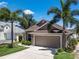 Charming single-story home featuring lush landscaping and a two-car garage at 144 Bridgeton St, Davenport, FL 33896