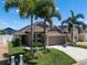 Well maintained single-story home featuring lush landscaping, and a two-car garage at 144 Bridgeton St, Davenport, FL 33896