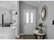 Welcoming foyer features wood-look flooring and stylish decor at 144 Bridgeton St, Davenport, FL 33896