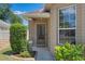 Covered front entrance with well-maintained landscaping and a large window at 144 Bridgeton St, Davenport, FL 33896