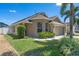 Well-maintained home with green landscaping and a two-car garage at 144 Bridgeton St, Davenport, FL 33896