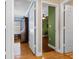 Bright hallway with hardwood flooring, leading to rooms with white trim at 144 Bridgeton St, Davenport, FL 33896