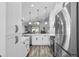 Open kitchen with stainless steel appliances and modern cabinets with great flow into living area at 144 Bridgeton St, Davenport, FL 33896