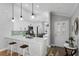 Bright, modern kitchen with quartz countertops, stainless steel appliances, and sleek pendant lighting at 144 Bridgeton St, Davenport, FL 33896