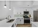 Modern kitchen featuring quartz countertops, stainless steel appliances, and wood look floors at 144 Bridgeton St, Davenport, FL 33896