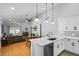 Open-concept living with kitchen featuring quartz countertops, stainless appliances, and seamless flow to living area at 144 Bridgeton St, Davenport, FL 33896