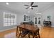 Comfortable living room featuring a ceiling fan, hardwood floors, and natural lighting at 144 Bridgeton St, Davenport, FL 33896