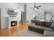 Cozy living room with fireplace seamlessly connects to the modern kitchen and dining area at 144 Bridgeton St, Davenport, FL 33896