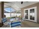 Screened patio with ceiling fan, seating, and double doors enhances outdoor living space at 144 Bridgeton St, Davenport, FL 33896